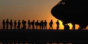 Line of defense soldiers boarding a military plane